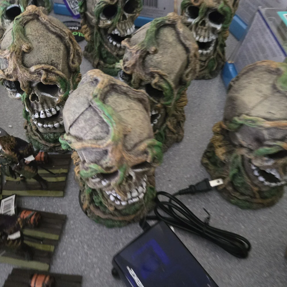 Decorative Skull Figurines with Green Accents